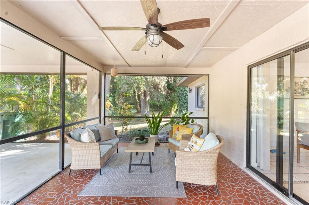 1030 13th Street Southwest Naples, FL 34117 - Photo 24 of 43 a living room with furniture and a floor to ceiling window