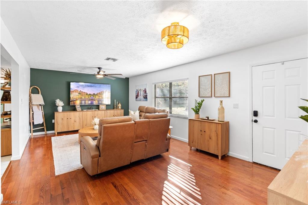 1030 13th Street Southwest Naples, FL 34117 - Photo 5 of 43 a living room with furniture and a wooden floor