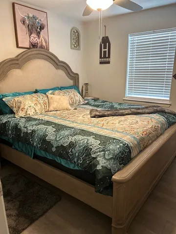 a view of a livingroom with wooden floor and a large window