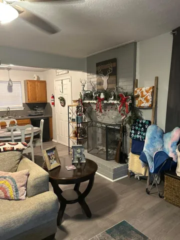 a living room with furniture a rug and a flat screen tv