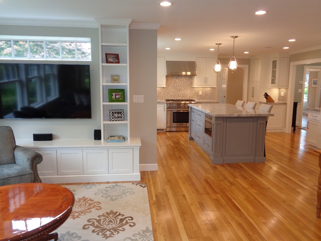 91 Winding River Road Needham, MA 02492 - Photo 14 of 27 a large kitchen with stainless steel appliances kitchen island granite countertop a refrigerator a stove a sink and a dining table with wooden floor
