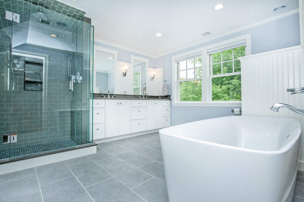 91 Winding River Road Needham, MA 02492 - Photo 17 of 27 a white bath tub sitting in a en suite bathroom