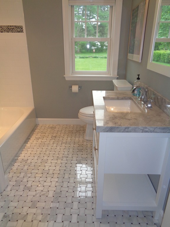91 Winding River Road Needham, MA 02492 - Photo 19 of 27 a bathroom with a granite countertop sink a toilet and a window