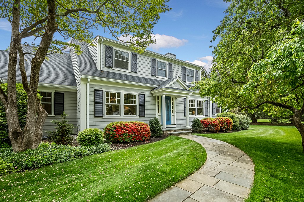 91 Winding River Road Needham, MA 02492 - Photo 4 of 27 a front view of a house with a garden