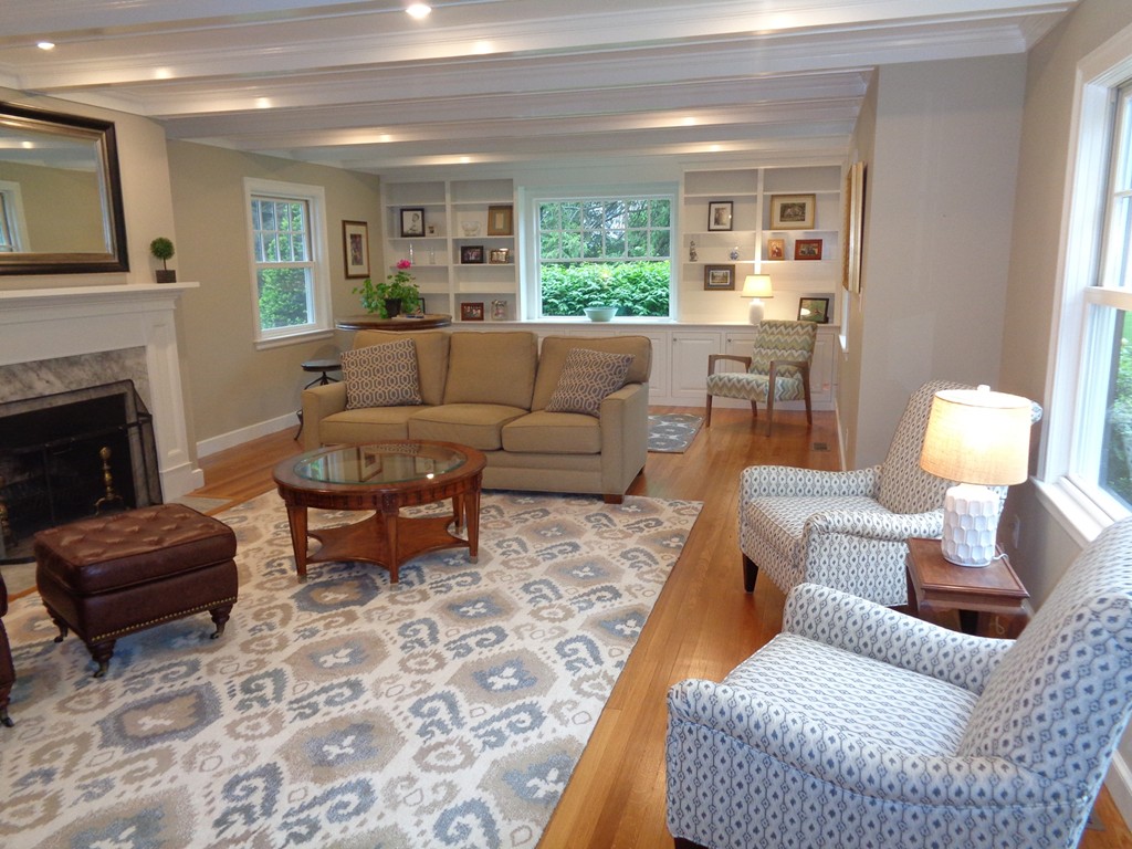 91 Winding River Road Needham, MA 02492 - Photo 8 of 27 a living room with furniture and a fireplace