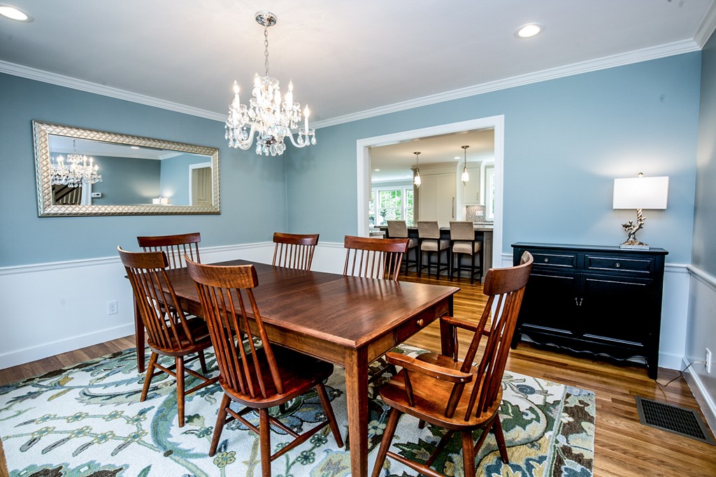 91 Winding River Road Needham, MA 02492 - Photo 9 of 27 a view of a dining room with furniture and chandelier