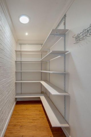a view of empty room with wooden floor and window