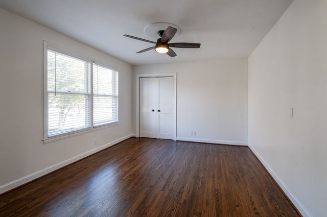 a bathroom with a granite countertop toilet and a sink