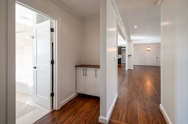 a view of empty room with wooden floor and fireplace