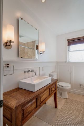 a view of an empty room with a fireplace and a window