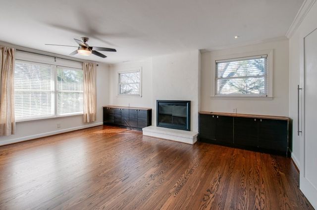 a view of balcony with wooden floor and fence