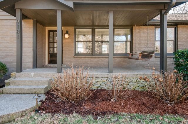 a view of a livingroom with wooden floor and a fireplace