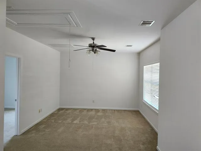 a living room with chairs and a table with wooden floor