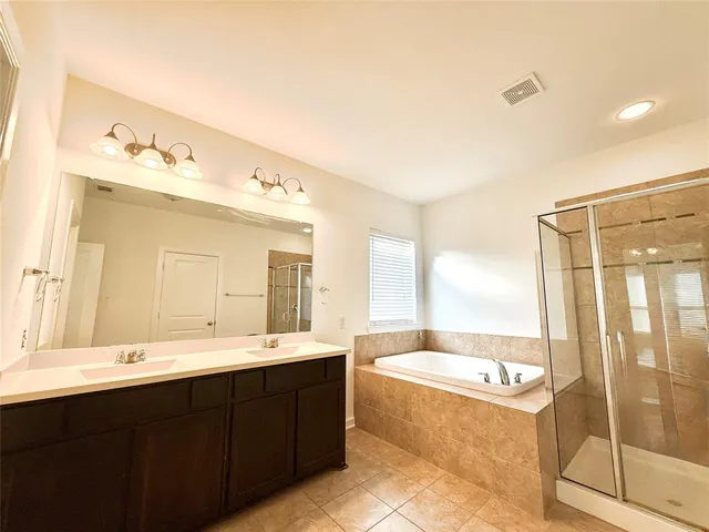 a kitchen with stainless steel appliances granite countertop a sink a stove top oven a granite counter top and utility