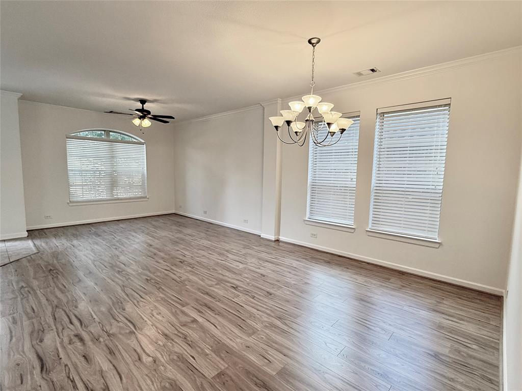 5737 Yorkshire Road McKinney, TX 75070 - Photo 19 of 19 a view of a room with wooden floors and a chandelier