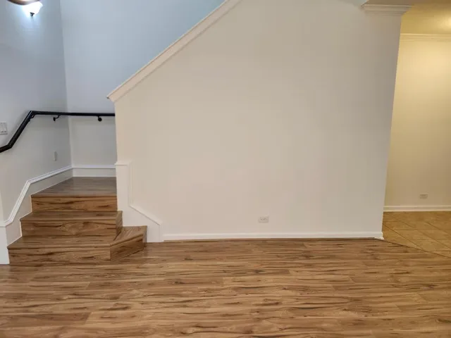 a view of room with wooden floor