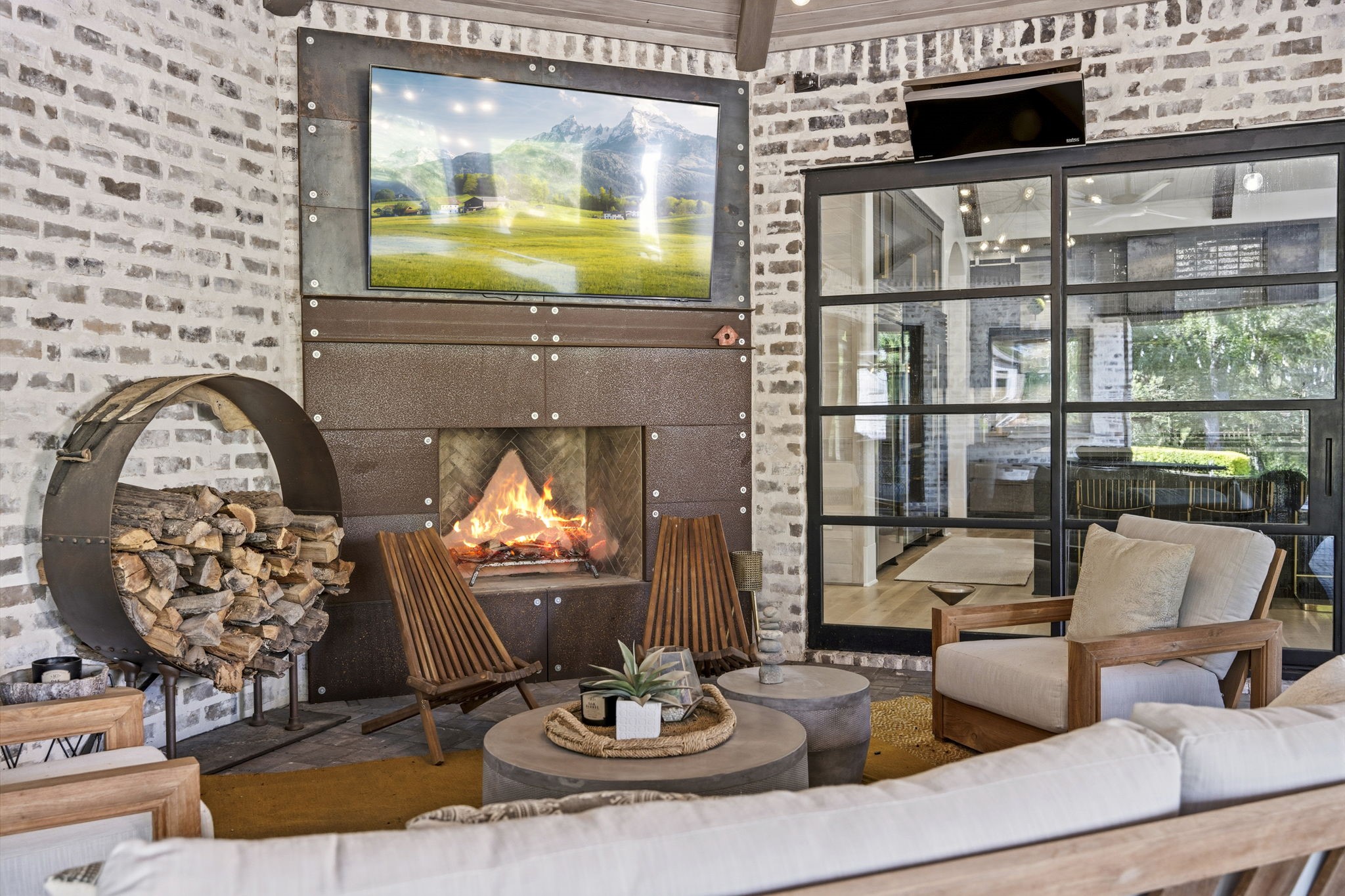 27006 Star Gazer Way Spring, TX 77386 - Photo 47 of 50 Designed for year-round enjoyment, this outdoor retreat features a cozy fireplace, mounted TV, and a beautifully appointed entertaining space perfect for gatherings.