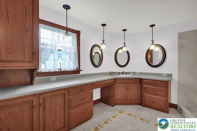 a view of an empty room with window and hardwood floor