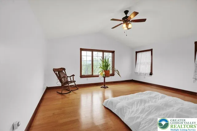a living room with furniture a fireplace and a window