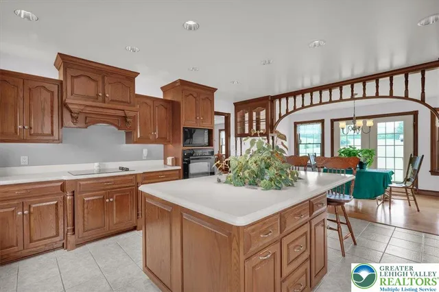 a kitchen that has a lot of cabinets in it and wooden floors
