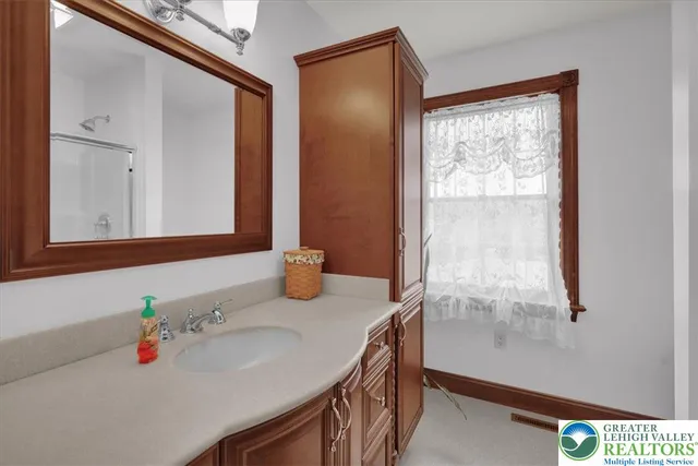 a view of an empty room with closet and a fireplace