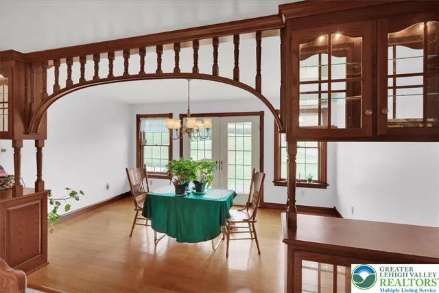a view of a big house with a big yard and large trees