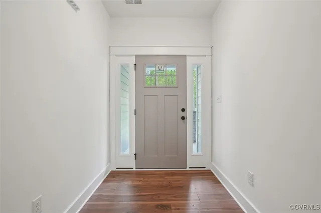 a view of an entryway with wooden floor