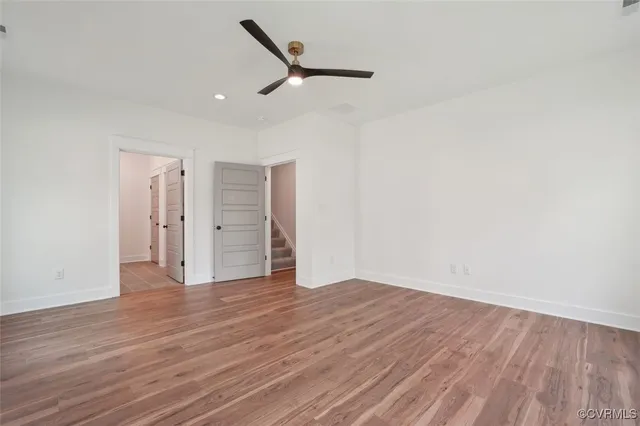 a kitchen with stainless steel appliances granite countertop a stove and a wooden floors