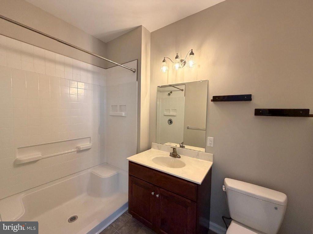 134 Bridge Street, Unit 201 Phoenixville, PA 19460 - Photo 12 of 12 a bathroom with a sink toilet a mirror and shower