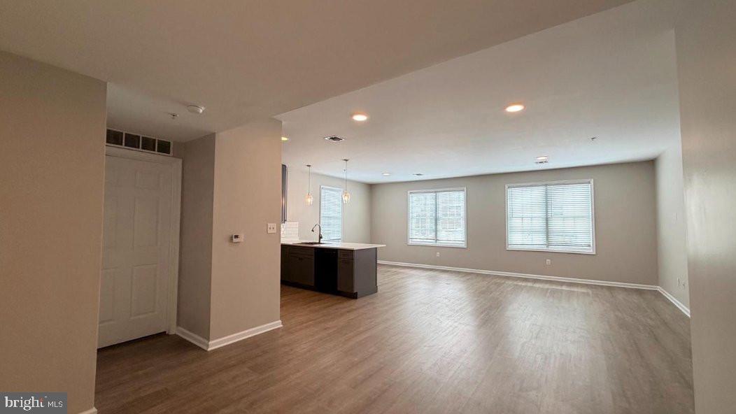 134 Bridge Street, Unit 201 Phoenixville, PA 19460 - Photo 4 of 12 a view of an empty room with wooden floor and a window