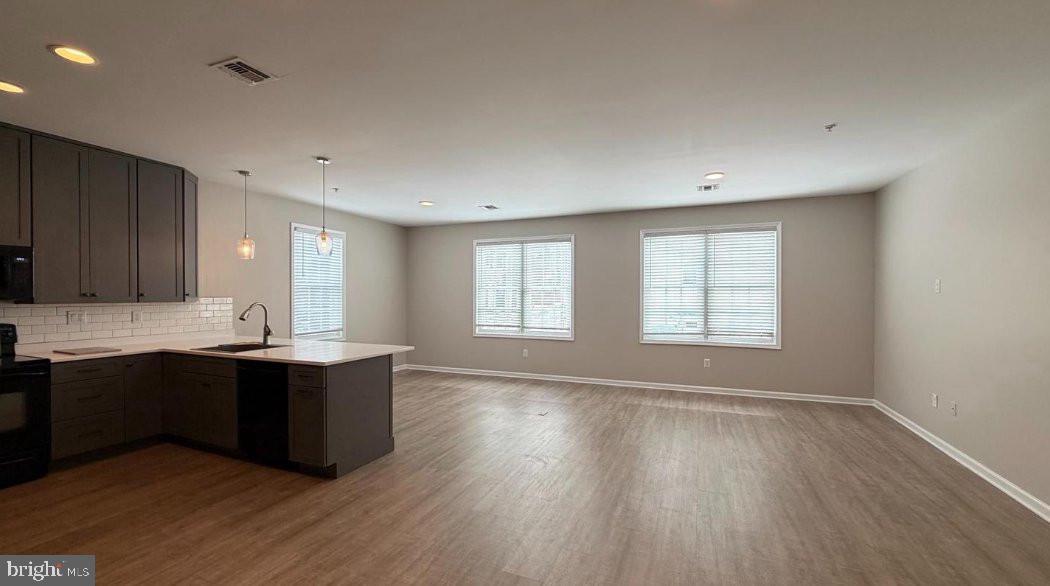 134 Bridge Street, Unit 201 Phoenixville, PA 19460 - Photo 6 of 12 a view of kitchen with sink and wooden floor