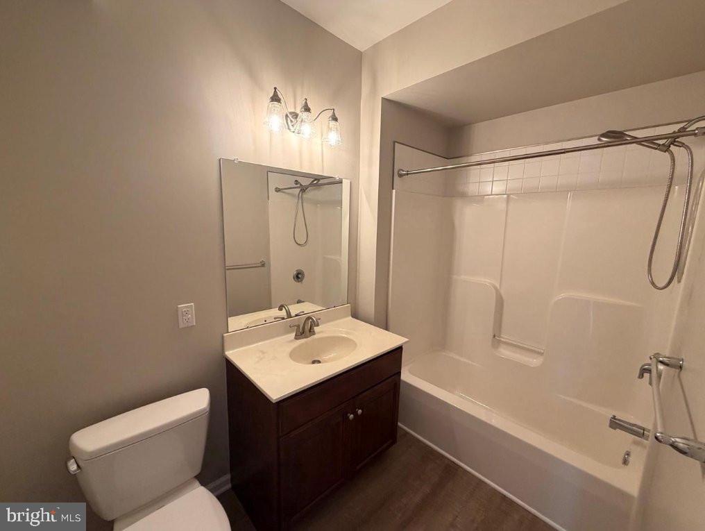 134 Bridge Street, Unit 201 Phoenixville, PA 19460 - Photo 9 of 12 a bathroom with a sink mirror vanity and toilet