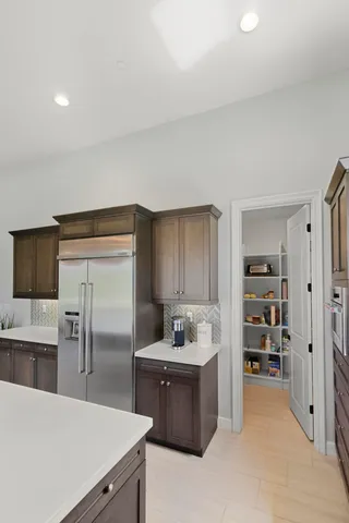 a kitchen with stainless steel appliances a refrigerator and a stove top oven