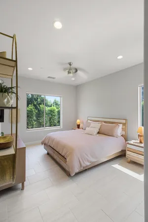 a bedroom with a bed and a chandelier