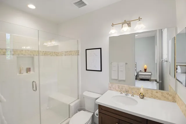 a bathroom with a sink shower and a mirror