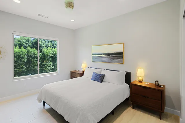 a bedroom with a bed and window