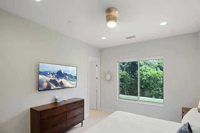 a view of a livingroom with wooden floor and window