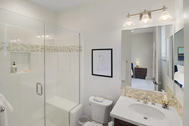 a bathroom with a sink toilet and shower