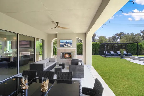 a living room with furniture floor to ceiling window and a table