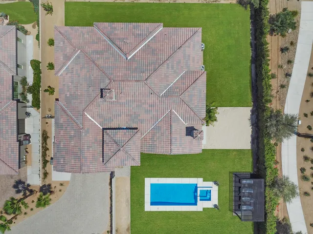 an aerial view of a house with a yard