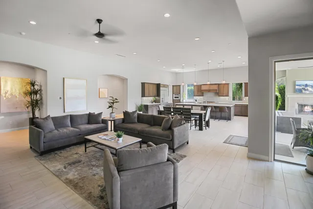 a living room with furniture and view of kitchen