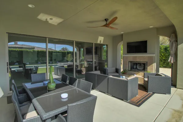 a living room with furniture a flat screen tv and a fireplace