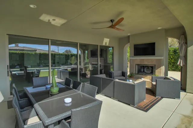 a living room with furniture a flat screen tv and a fireplace