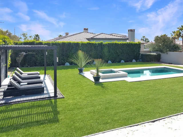 a view of a house with a backyard