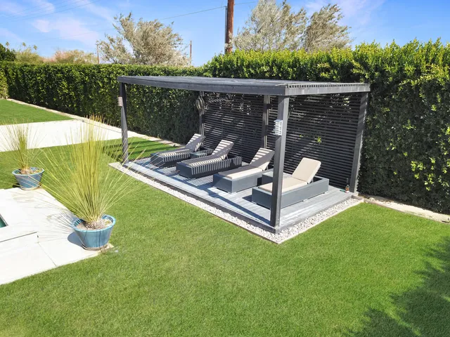 a view of a chairs and backyard with a roof deck