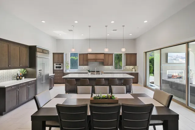 a large kitchen with a table and chairs