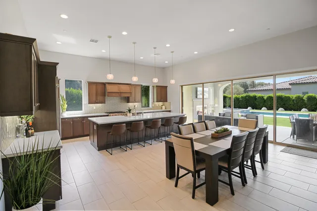 a large kitchen with a table and chairs