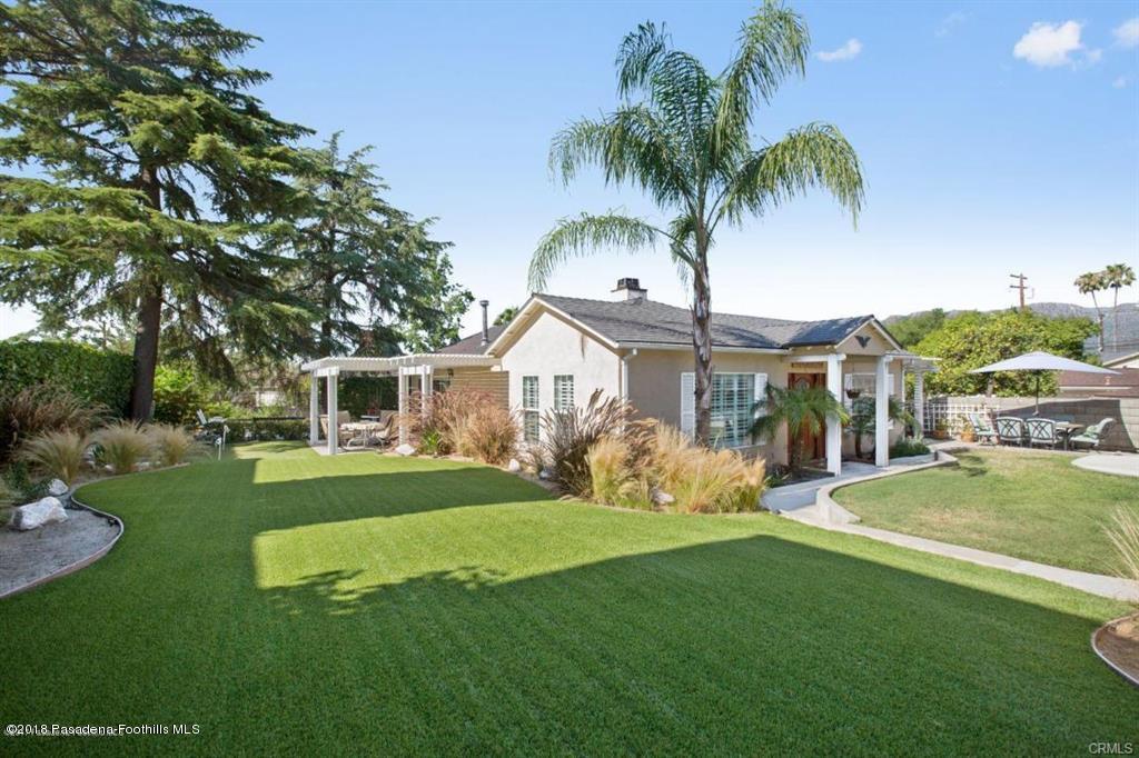 a front view of a house with garden and porch