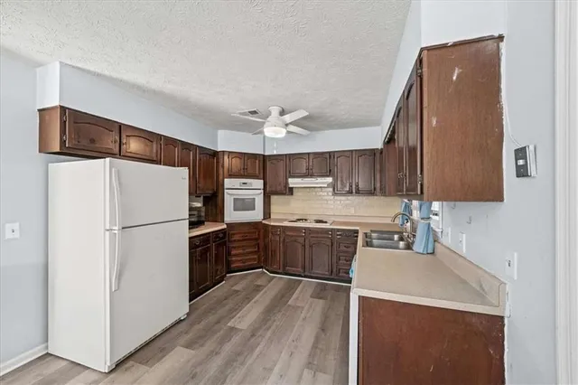 a kitchen with a refrigerator and a sink
