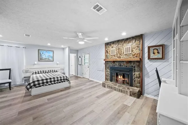 a view of a livingroom with a fireplace and window